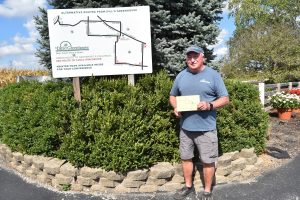 Jerry Dill in front of signage he had post to help drivers.