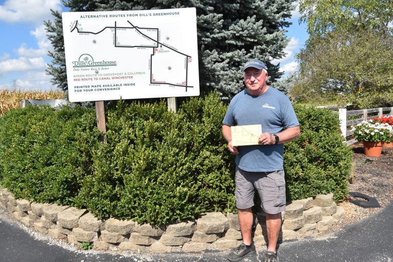 Jerry Dill in front of signage he had post to help drivers.